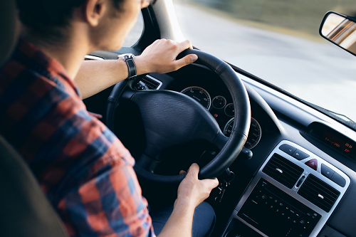 a person at a steering wheel