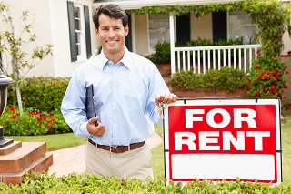 Man next to rent sign