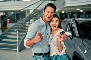 couple holding keys to new car