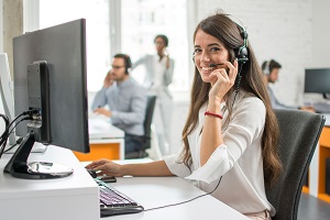 woman smiling at camera with headset on