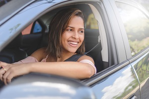 teenage woman driving a car