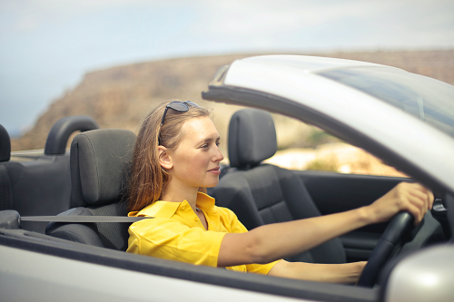 a person sitting on the seat of a car